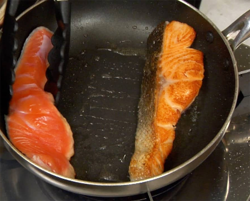 Công đoạn áp chảo thịt cá hồi phi lê ướp muối tiêu. 